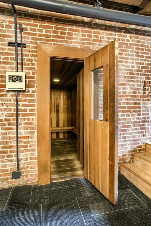 308 W 8th St Unit 420, Kansas City, MO 64105 - relaxing sauna with wooden walls and brick wall