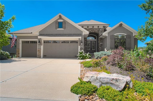 10423 W 168th Ter, Overland Park, KS 66221 - view of front of house with french doors, stone siding, an attached garage, and concrete driveway