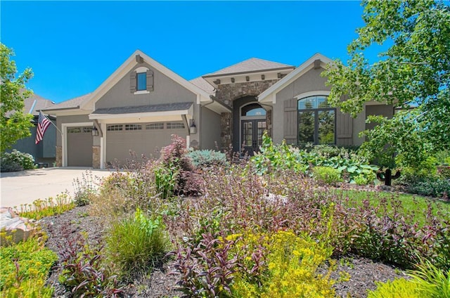 10423 W 168th Ter, Overland Park, KS 66221 - view of front of property with stone siding, an attached garage, french doors, driveway, and stucco siding