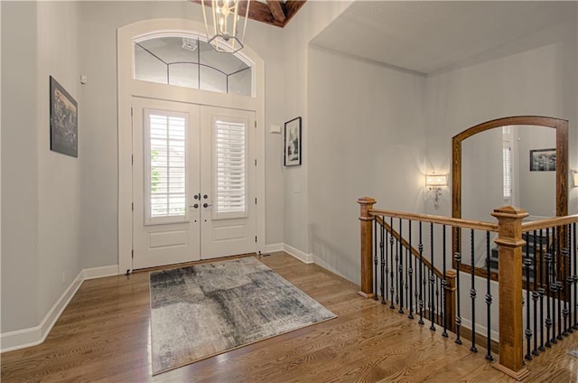 10423 W 168th Ter, Overland Park, KS 66221 - foyer entrance with wood finished floors, arched walkways, french doors, and a towering ceiling