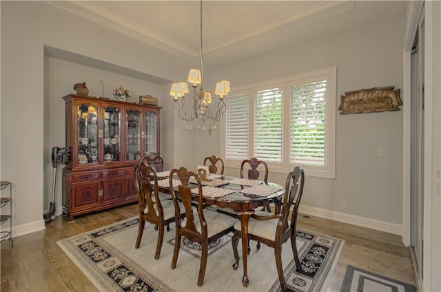10423 W 168th Ter, Overland Park, KS 66221 - dining space with light wood finished floors, a chandelier, and crown molding