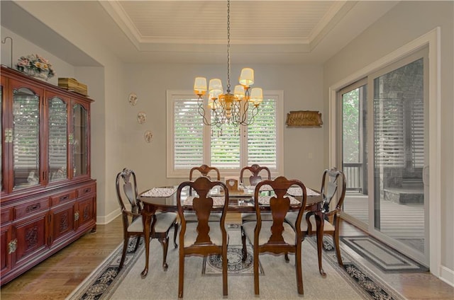 10423 W 168th Ter, Overland Park, KS 66221 - dining area with a chandelier, a raised ceiling, and light wood-type flooring