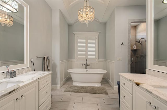 10423 W 168th Ter, Overland Park, KS 66221 - bathroom featuring a chandelier, two vanities, a freestanding bath, a stall shower, and lofted ceiling