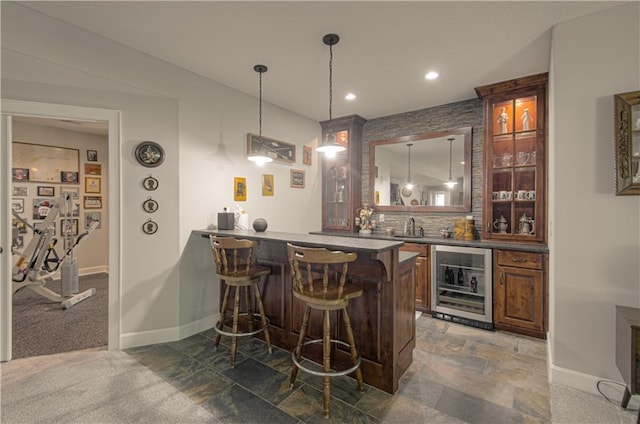 10423 W 168th Ter, Overland Park, KS 66221 - indoor wet bar featuring wine cooler, recessed lighting, decorative light fixtures, stone finish floors, and backsplash