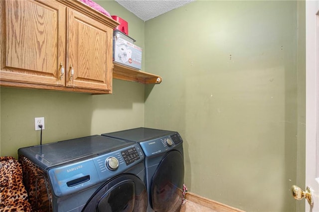 4407 SW Briarbrook Dr, Lees Summit, MO 64082 - laundry area featuring cabinet space, washer and clothes dryer, and a textured ceiling