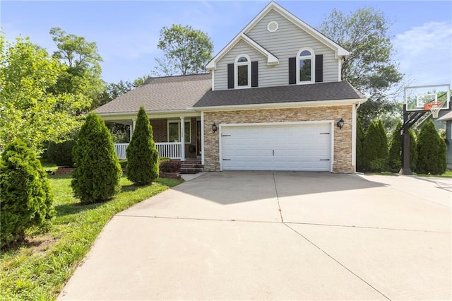 1125 S Mulberry St, Ottawa, KS 66067 - traditional-style home featuring driveway, a porch, a garage, stone siding, and roof with shingles