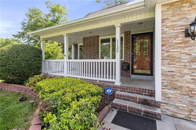 1125 S Mulberry St, Ottawa, KS 66067 - doorway to property with a porch and brick siding