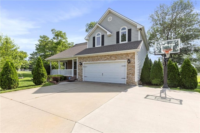 1125 S Mulberry St, Ottawa, KS 66067 - traditional-style home featuring driveway, stone siding, a garage, and a porch