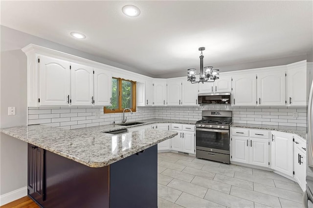1125 S Mulberry St, Ottawa, KS 66067 - kitchen with stainless steel appliances, a peninsula, a chandelier, white cabinetry, and backsplash
