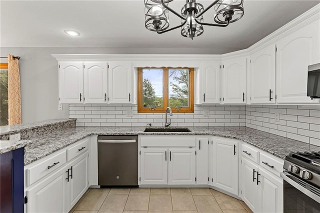 1125 S Mulberry St, Ottawa, KS 66067 - kitchen with appliances with stainless steel finishes, plenty of natural light, a chandelier, light tile patterned floors, and recessed lighting