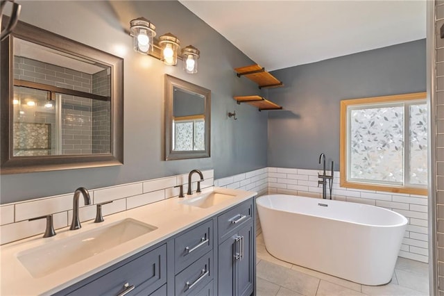 1125 S Mulberry St, Ottawa, KS 66067 - bathroom with tile walls, a soaking tub, tile patterned flooring, double vanity, and tiled shower