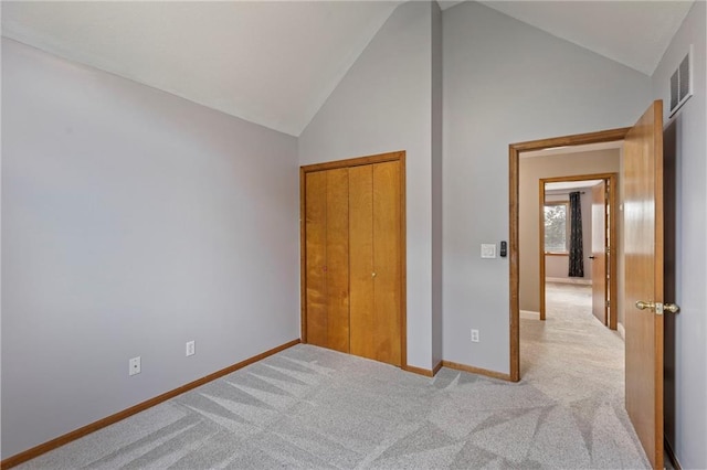 1125 S Mulberry St, Ottawa, KS 66067 - unfurnished bedroom with carpet flooring, high vaulted ceiling, and a closet