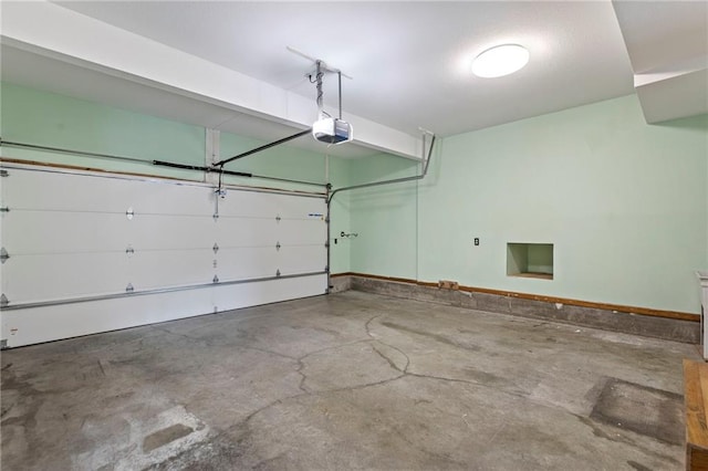 1125 S Mulberry St, Ottawa, KS 66067 - garage with a garage door opener and baseboards