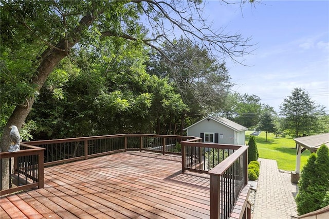 1125 S Mulberry St, Ottawa, KS 66067 - wooden deck featuring a lawn, an outdoor structure, and view of scattered trees
