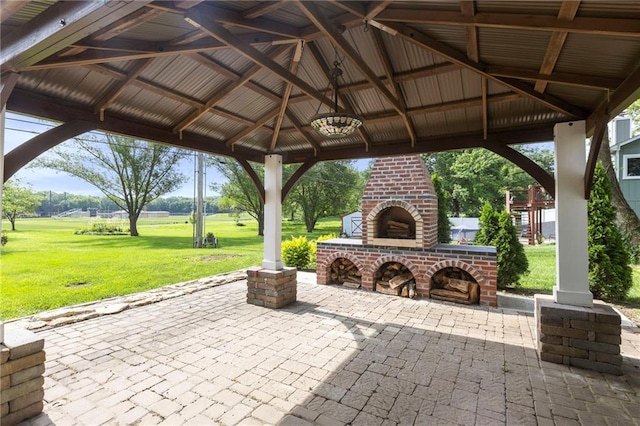 1125 S Mulberry St, Ottawa, KS 66067 - view of patio / terrace featuring an outdoor brick fireplace and a gazebo