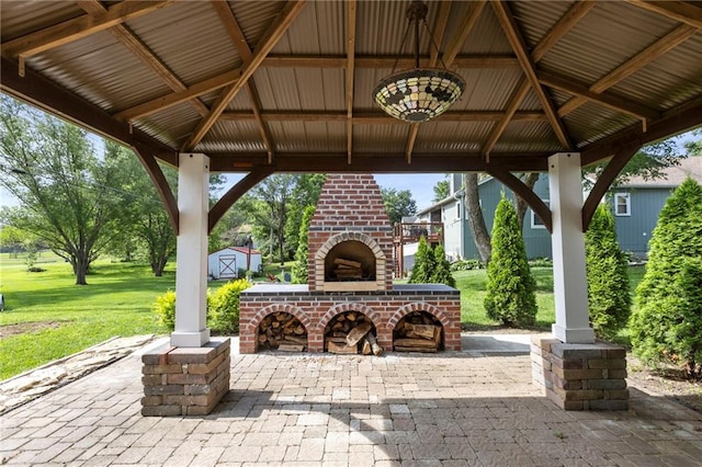 1125 S Mulberry St, Ottawa, KS 66067 - view of patio featuring a gazebo, an outdoor brick fireplace, and a storage shed
