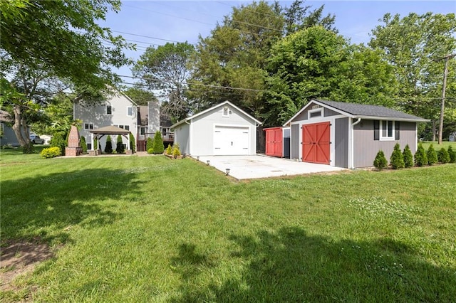 1125 S Mulberry St, Ottawa, KS 66067 - view of green lawn with a detached garage, a gazebo, and a shed