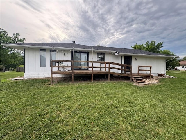 109 W 3rd St, Stanberry, MO 64489 - rear view of house featuring a wooden deck and a lawn