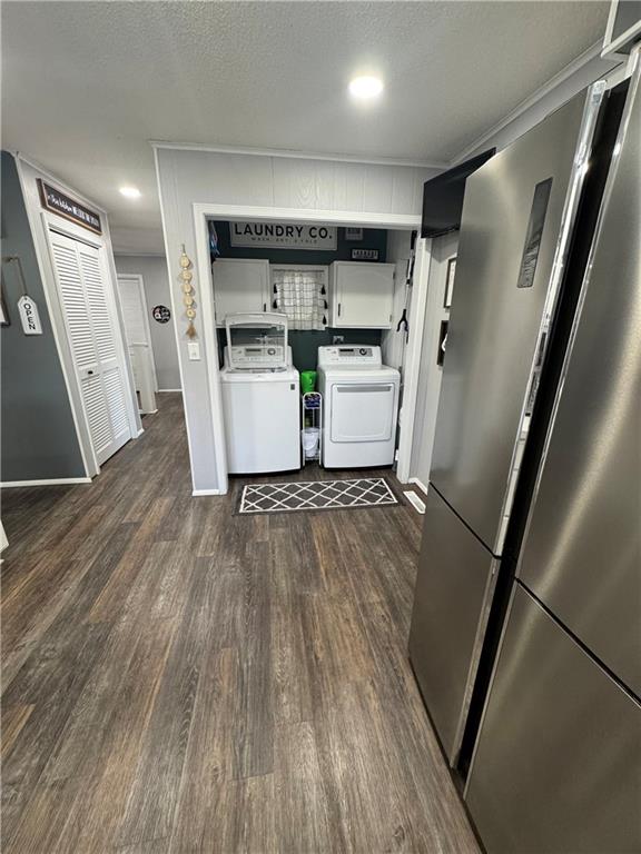 109 W 3rd St, Stanberry, MO 64489 - kitchen with freestanding refrigerator, dark wood-style floors, and independent washer and dryer