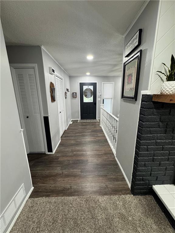 109 W 3rd St, Stanberry, MO 64489 - foyer entrance featuring wood finished floors and a textured ceiling