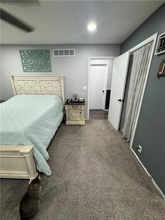 109 W 3rd St, Stanberry, MO 64489 - carpeted bedroom featuring a textured ceiling and ceiling fan