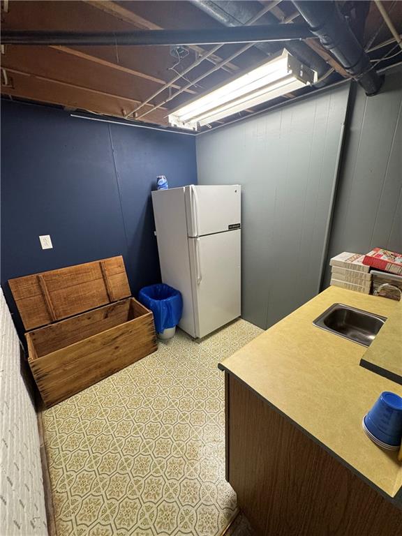 109 W 3rd St, Stanberry, MO 64489 - finished basement featuring freestanding refrigerator and light flooring
