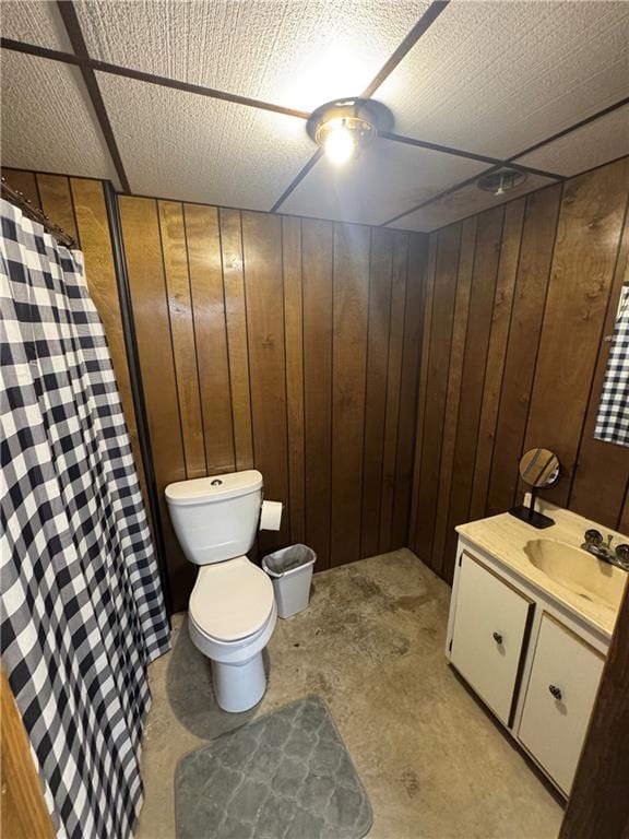 109 W 3rd St, Stanberry, MO 64489 - full bath with vanity, wooden walls, and curtained shower