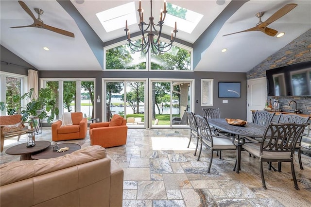6 Mohave Dr, Lake Winnebago, MO 64034 - living area with a skylight, a ceiling fan, stone tile floors, and high vaulted ceiling