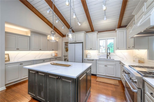 6 Mohave Dr, Lake Winnebago, MO 64034 - kitchen with track lighting, appliances with stainless steel finishes, custom range hood, wood ceiling, and hardwood / wood-style floors