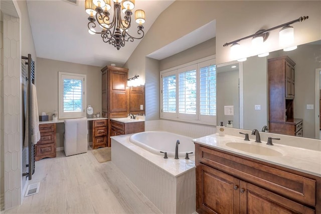 6 Mohave Dr, Lake Winnebago, MO 64034 - full bathroom featuring lofted ceiling, healthy amount of natural light, two vanities, and a bath