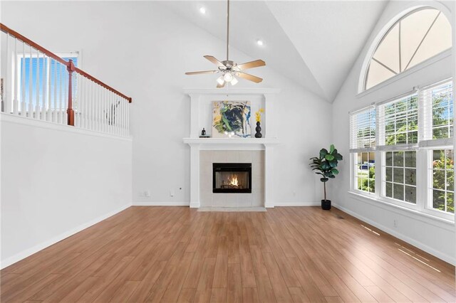 16778 W 156th Ter, Olathe, KS 66062 - unfurnished living room with a fireplace, ceiling fan, wood finished floors, and high vaulted ceiling