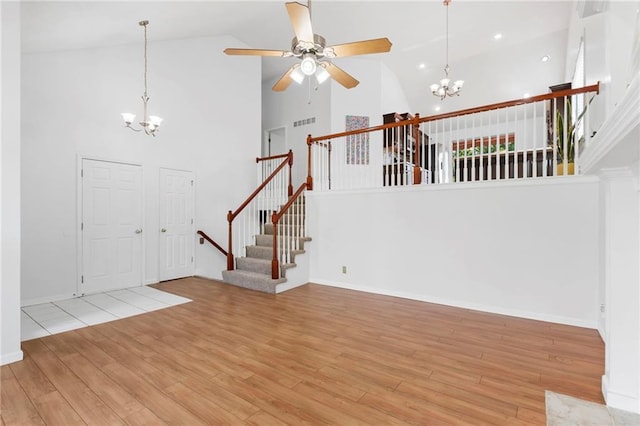 16778 W 156th Ter, Olathe, KS 66062 - entrance foyer featuring a chandelier, high vaulted ceiling, a ceiling fan, stairs, and wood finished floors