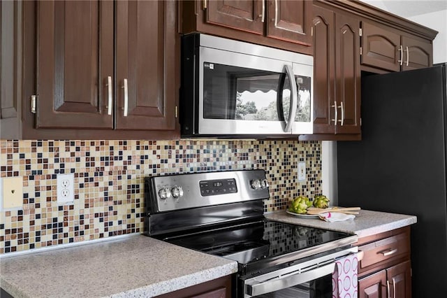 16778 W 156th Ter, Olathe, KS 66062 - kitchen with appliances with stainless steel finishes, tasteful backsplash, light countertops, and dark brown cabinetry