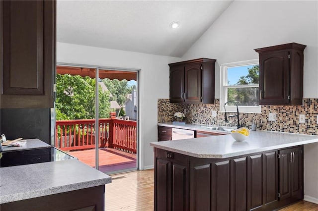 16778 W 156th Ter, Olathe, KS 66062 - kitchen with light countertops, decorative backsplash, vaulted ceiling, dark brown cabinetry, and recessed lighting