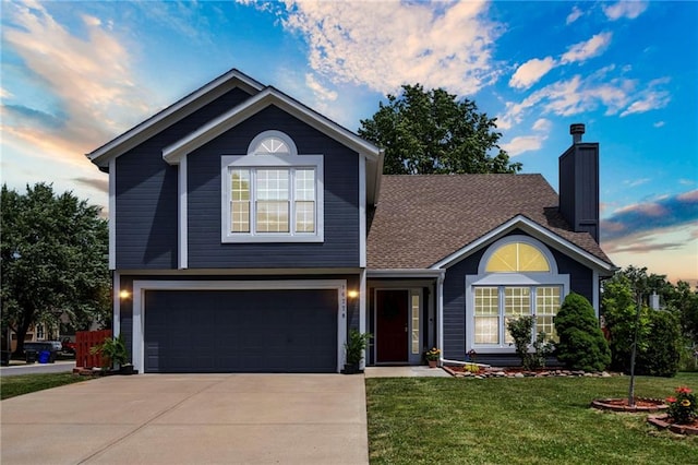 16778 W 156th Ter, Olathe, KS 66062 - traditional-style house featuring an attached garage, driveway, a front yard, a chimney, and roof with shingles