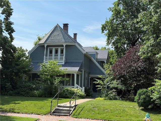 222 W Gay St, Warrensburg, MO 64093 - shingle-style home featuring a balcony, a chimney, and a front yard