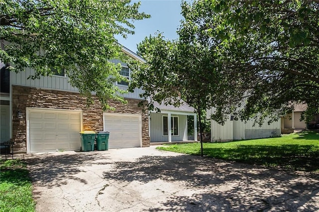 10151 W 84th St, Overland Park, KS 66212 - view of front facade with concrete driveway, a front lawn, and a garage