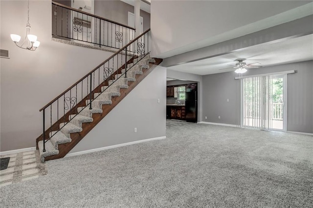 10151 W 84th St, Overland Park, KS 66212 - staircase with carpet, ceiling fan, a chandelier, and a towering ceiling