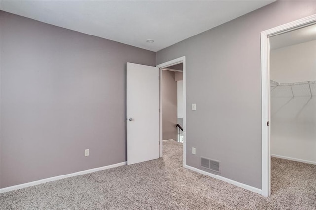 10151 W 84th St, Overland Park, KS 66212 - unfurnished bedroom featuring carpet floors, a walk in closet, and a closet