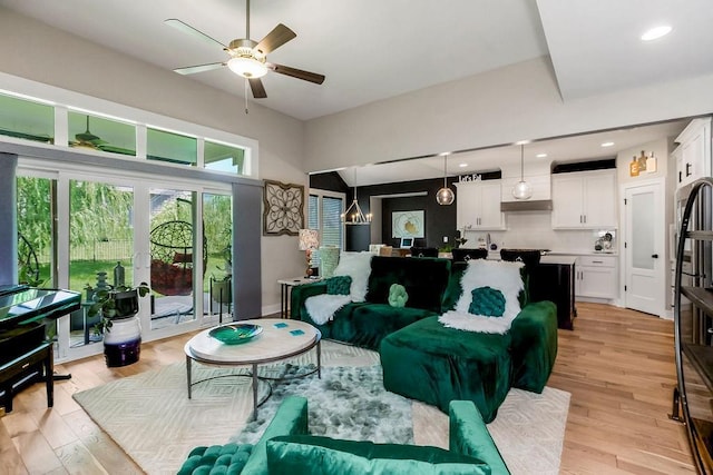 6614 Mccormick Dr, Shawnee, KS 66226 - living area featuring a ceiling fan, light wood-type flooring, and a chandelier