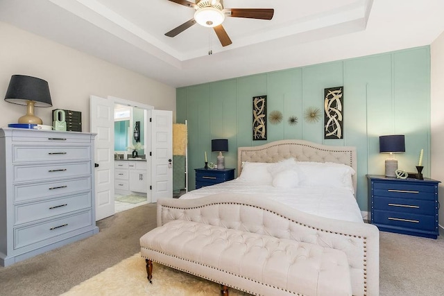 6614 Mccormick Dr, Shawnee, KS 66226 - bedroom with light colored carpet, a tray ceiling, ensuite bath, and a ceiling fan