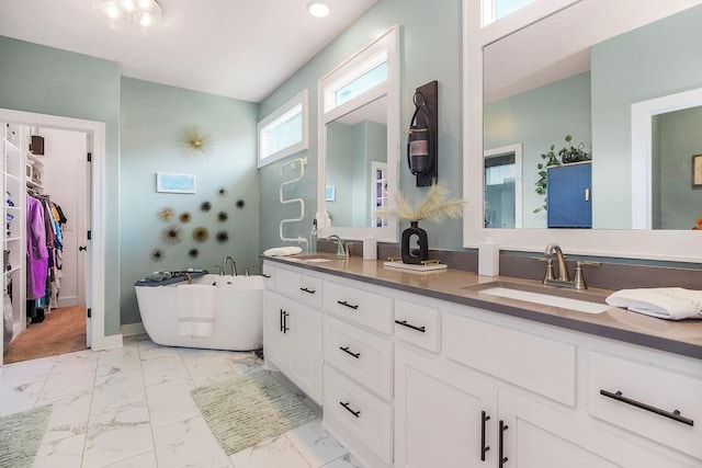 6614 Mccormick Dr, Shawnee, KS 66226 - full bathroom with marble look tile flooring, double vanity, a soaking tub, and a walk in closet