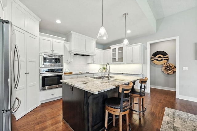 16486 S Chalet Dr, Olathe, KS 66062 - kitchen with stainless steel appliances, white cabinets, tasteful backsplash, light stone counters, and recessed lighting