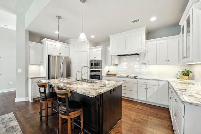16486 S Chalet Dr, Olathe, KS 66062 - kitchen featuring stainless steel appliances, backsplash, white cabinetry, and recessed lighting