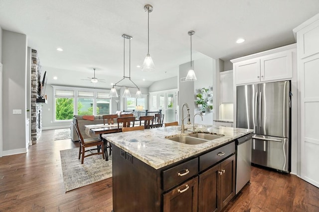 16486 S Chalet Dr, Olathe, KS 66062 - kitchen with appliances with stainless steel finishes, white cabinets, dark brown cabinets, dark wood-style flooring, and light stone counters
