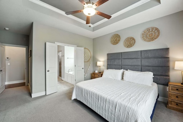 16486 S Chalet Dr, Olathe, KS 66062 - bedroom with carpet floors, a tray ceiling, connected bathroom, and ceiling fan