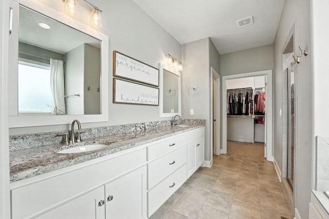 16486 S Chalet Dr, Olathe, KS 66062 - full bathroom with double vanity and a walk in closet