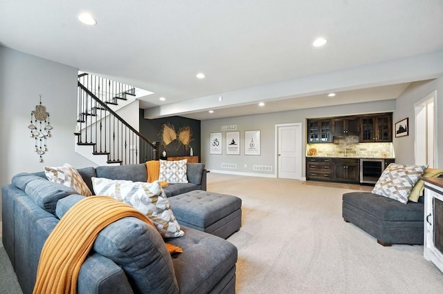 16486 S Chalet Dr, Olathe, KS 66062 - living room with light carpet, recessed lighting, stairs, a bar, and wine cooler