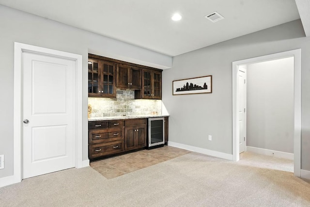 16486 S Chalet Dr, Olathe, KS 66062 - indoor dry bar featuring beverage cooler, light carpet, tasteful backsplash, and recessed lighting