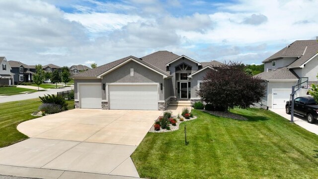 16486 S Chalet Dr, Olathe, KS 66062 - view of front of property with a garage, concrete driveway, a front lawn, and stucco siding